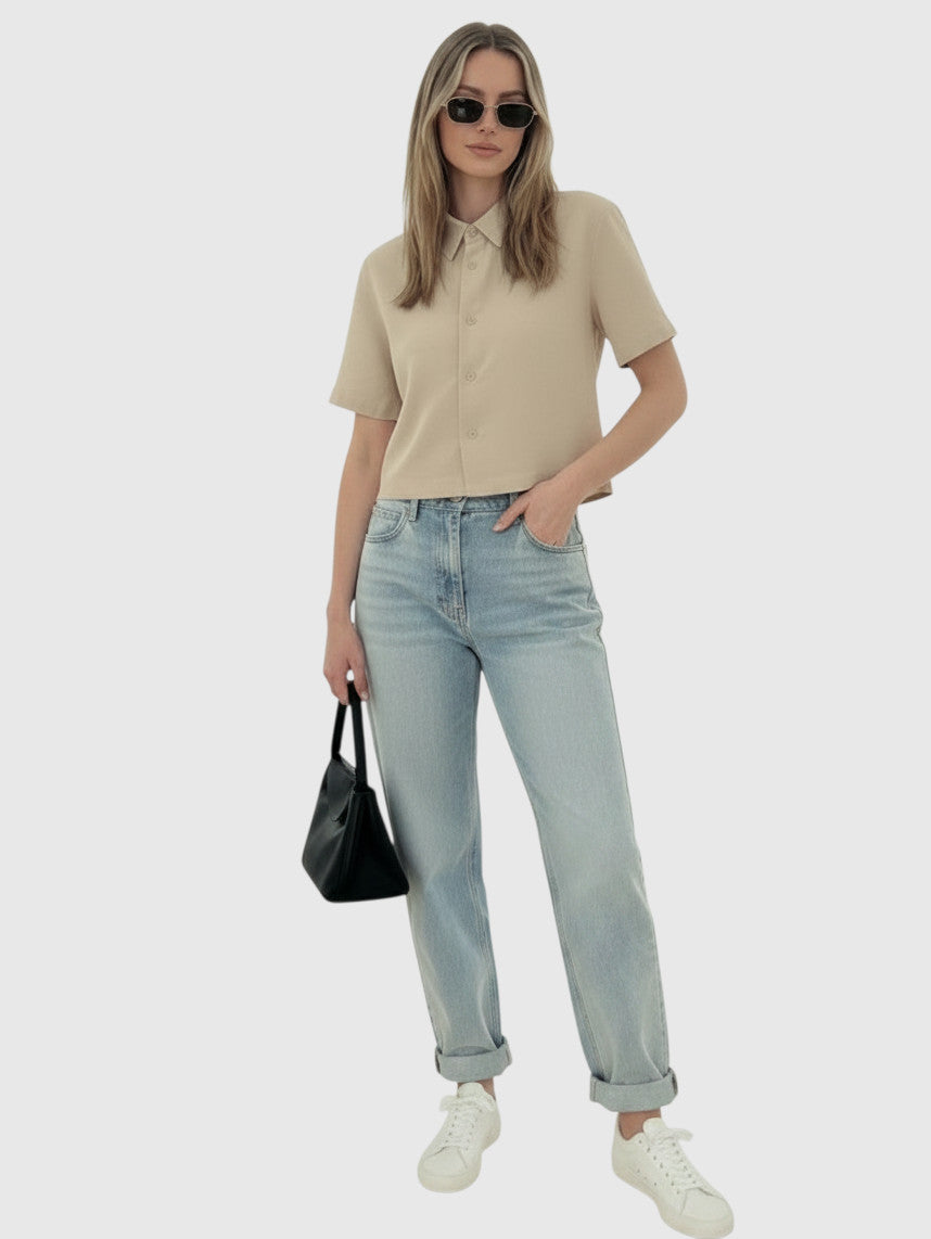 Clueless Paris beige cropped short sleeve button-down linen-blend shirt worn with light wash jeans and sunglasses