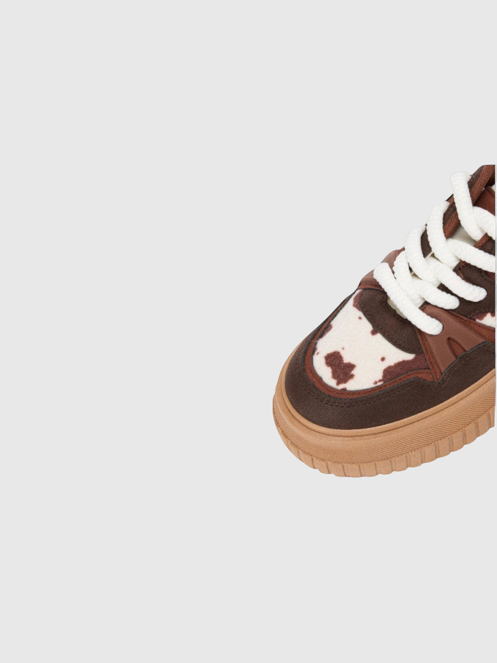 Clueless Paris chocolate brown platform sneakers with textured animal print, thick white laces, and lugged sole.
