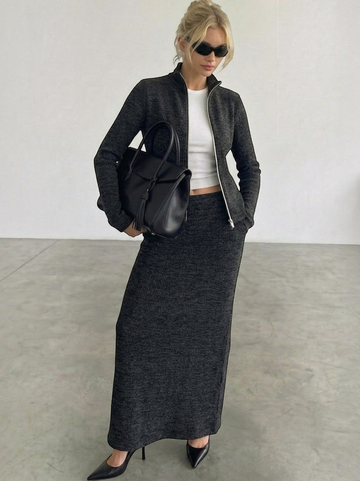 Clueless Paris charcoal grey textured knit zip-up jacket and matching long skirt set worn with a black handbag