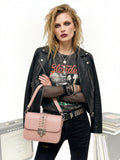 Clueless Paris dusty pink crossbody bag with stud details and metallic clasp worn by a model in a rock style outfit