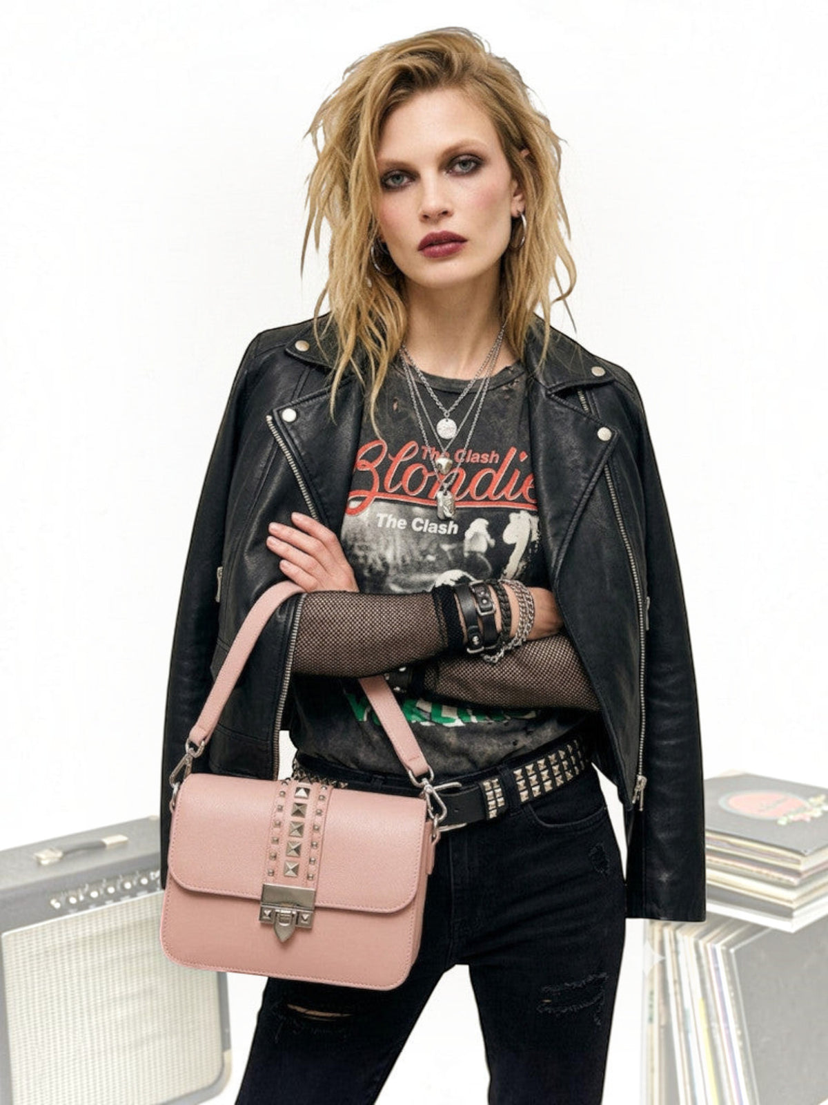 Clueless Paris dusty pink crossbody bag with stud details and metallic clasp worn by a model in a rock style outfit