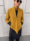 Clueless Paris mustard yellow textured bouclé short jacket with an open collar and asymmetric hem worn by a model.